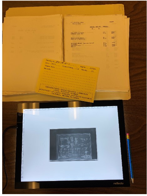 The plan for the Nanaimo Vocational School on a lightboard from GR-4108. The related index information (GR-2184) is displayed along with the negative envelope.